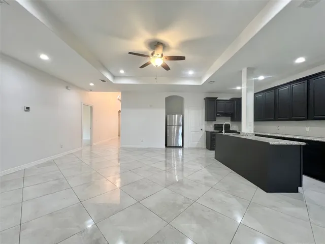 a view of kitchen with refrigerator and microwave