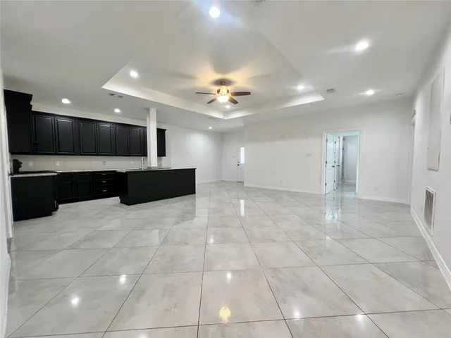 a view of kitchen with a sink and a stove top oven with kitchen island