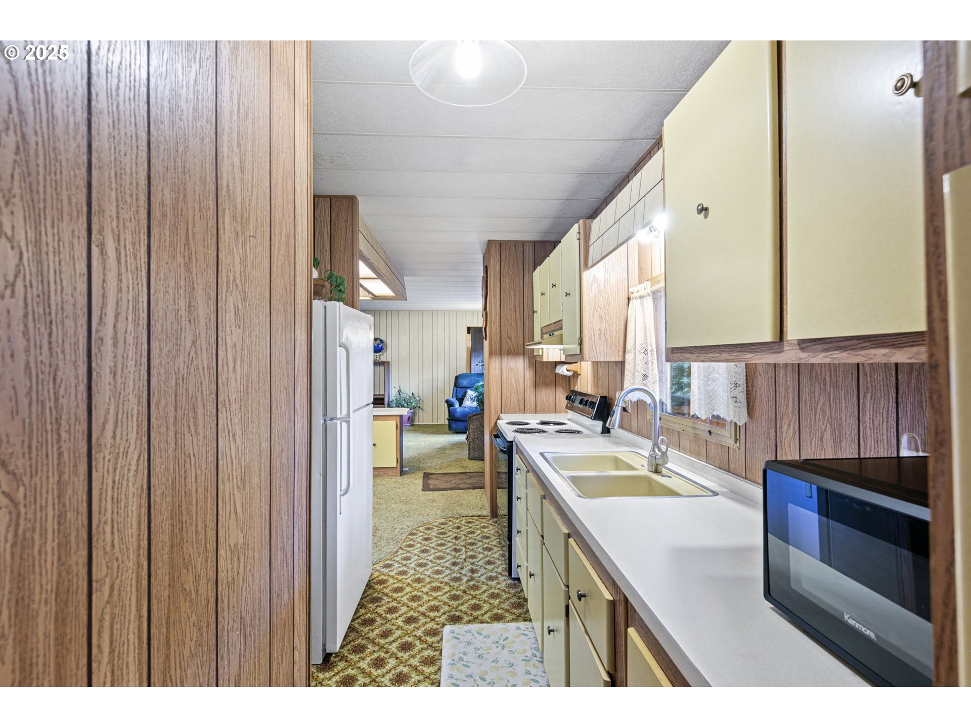 44531 McKenzie Highway Leaburg, OR 97489 - Photo 16 of 48 a kitchen with a sink and a refrigerator