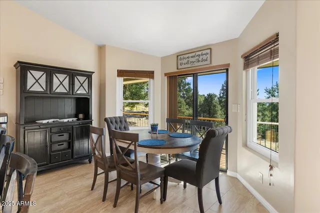 a dining room with furniture a chandelier and wooden floor