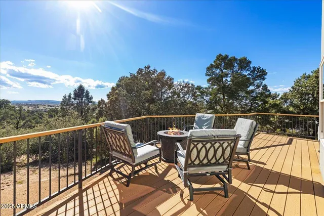 a view of a backyard with table and chairs with wooden fence