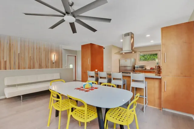 a dining room with furniture and wooden floor