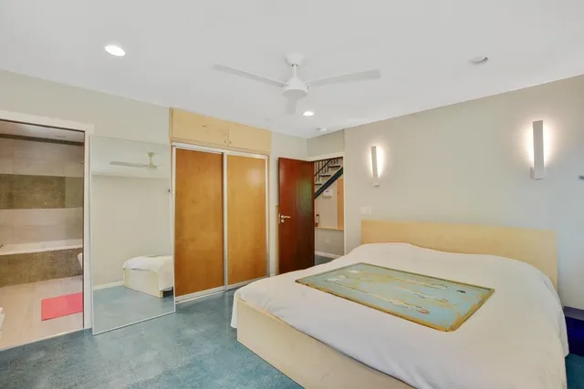 a bedroom with a bed and a cabinets