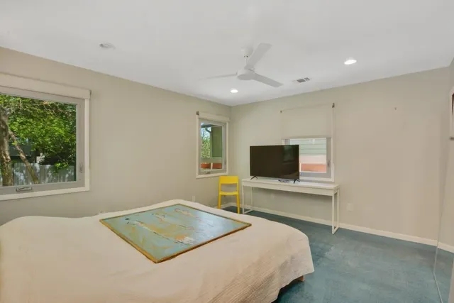 a bedroom with a bed and a flat screen tv