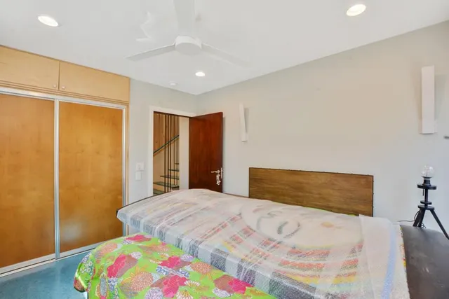 a bedroom with a bed and a dresser