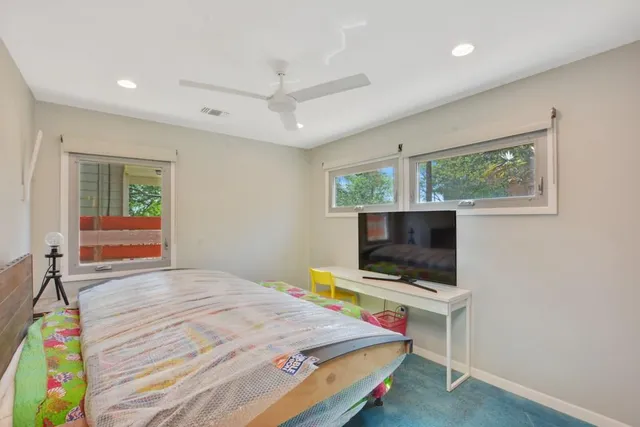 a bedroom with a bed and a flat screen tv