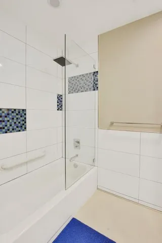 a bathroom with a bathtub and shower