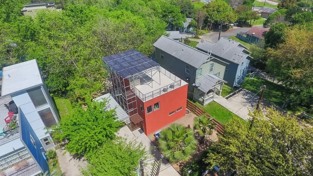 an aerial view of a house with garden space and street view
