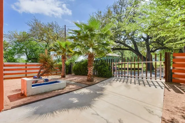 a view of a park with iron fence