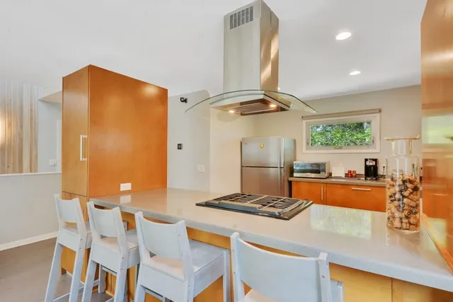 a kitchen with stainless steel appliances granite countertop a sink and a refrigerator