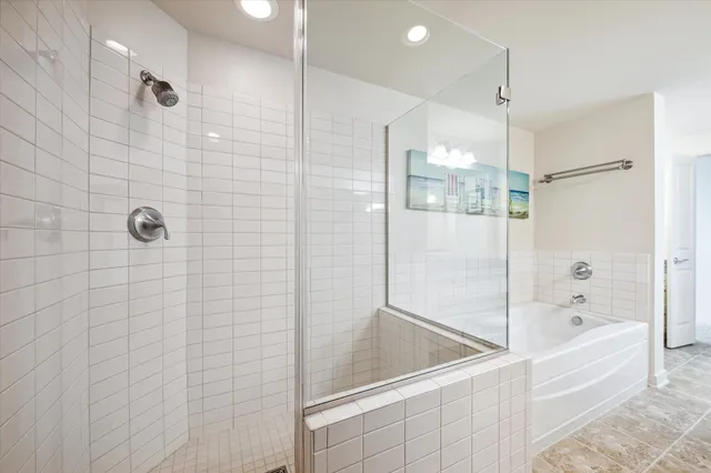 a bathroom with a granite countertop double vanity sink mirror and shower