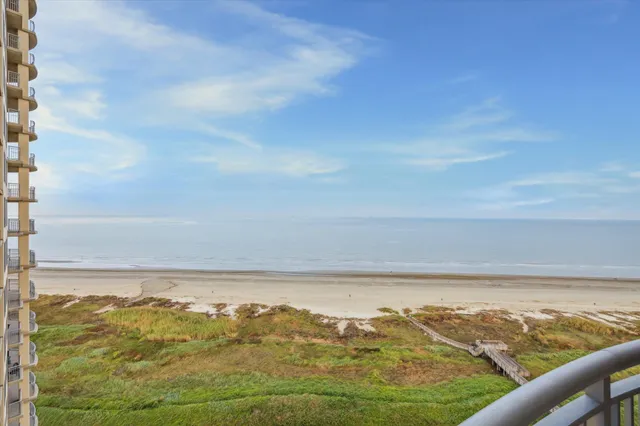 a living room with furniture kitchen view and a chandelier
