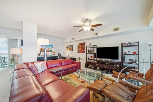 a kitchen with stainless steel appliances kitchen island granite countertop a refrigerator and a stove top oven