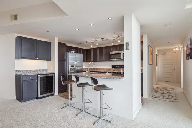 a spacious bedroom with a bed and a ceiling fan