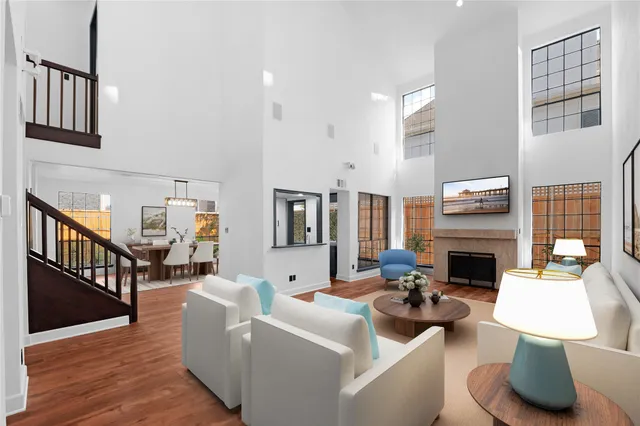 a living room with fireplace furniture and a wooden floor