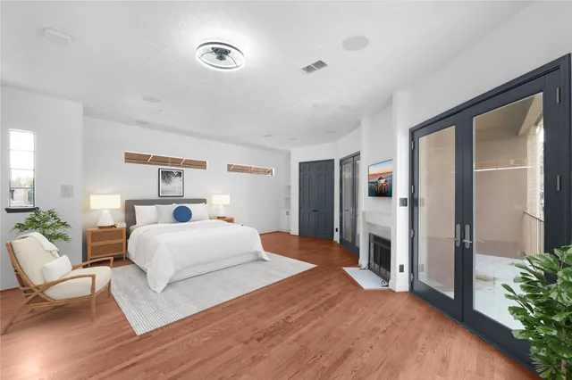 a bedroom with a large bed and a large window