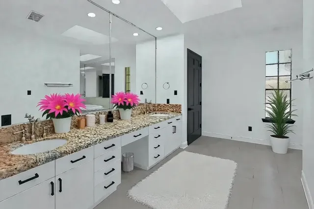 a kitchen with kitchen island granite countertop sink and white cabinets