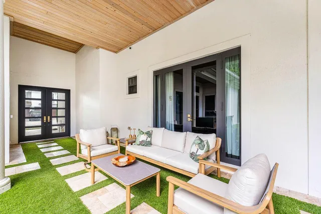 a view of a house with swimming pool and sitting area
