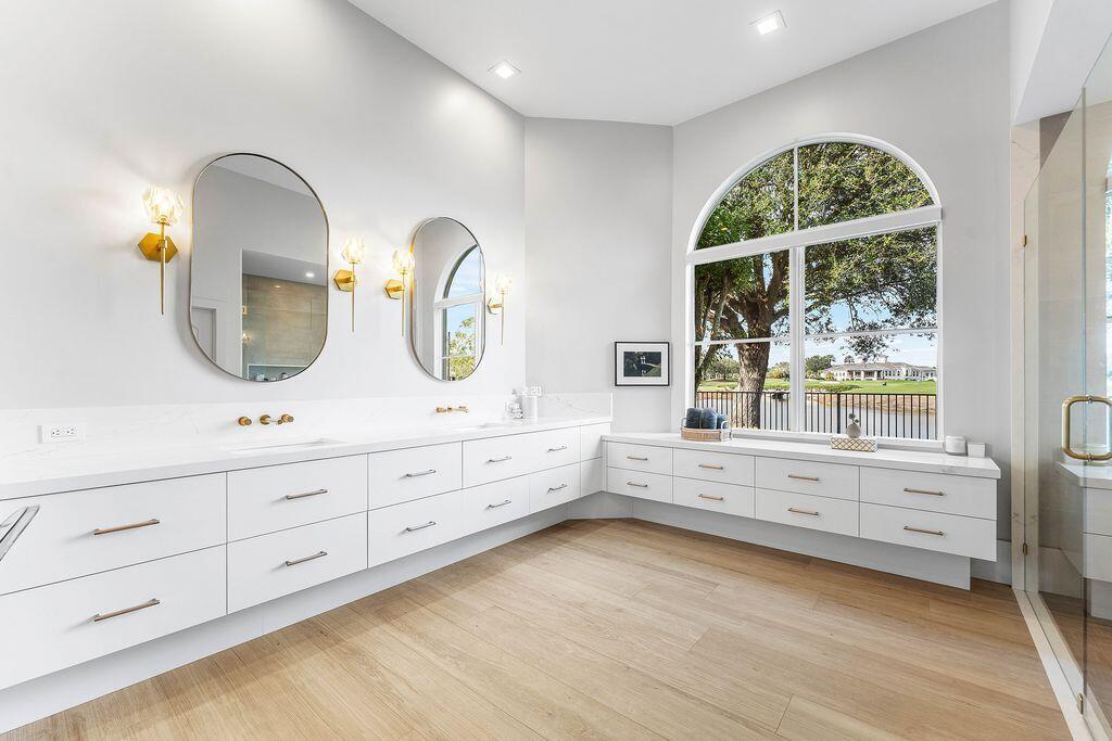 8849 Valhalla Drive Delray Beach, FL 33446 - Photo 22 of 51 a bathroom with a granite countertop double vanity sink a two mirror a window and a bathtub