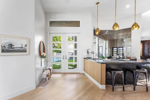 a kitchen with a stove a sink and a window