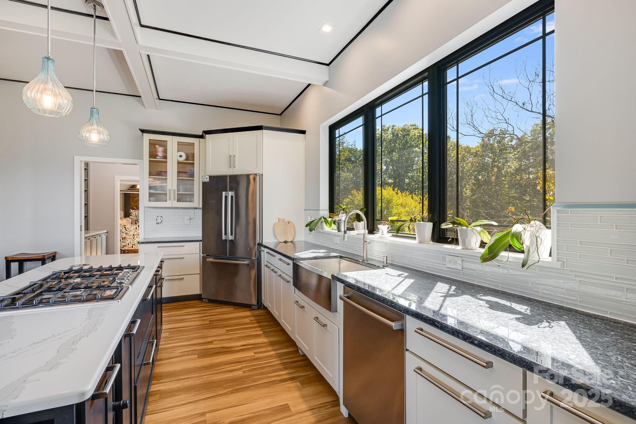 1387 Woods Ammons Road Mars Hill, NC 28754 - Photo 15 of 48 a kitchen with stainless steel appliances granite countertop a sink stove and refrigerator