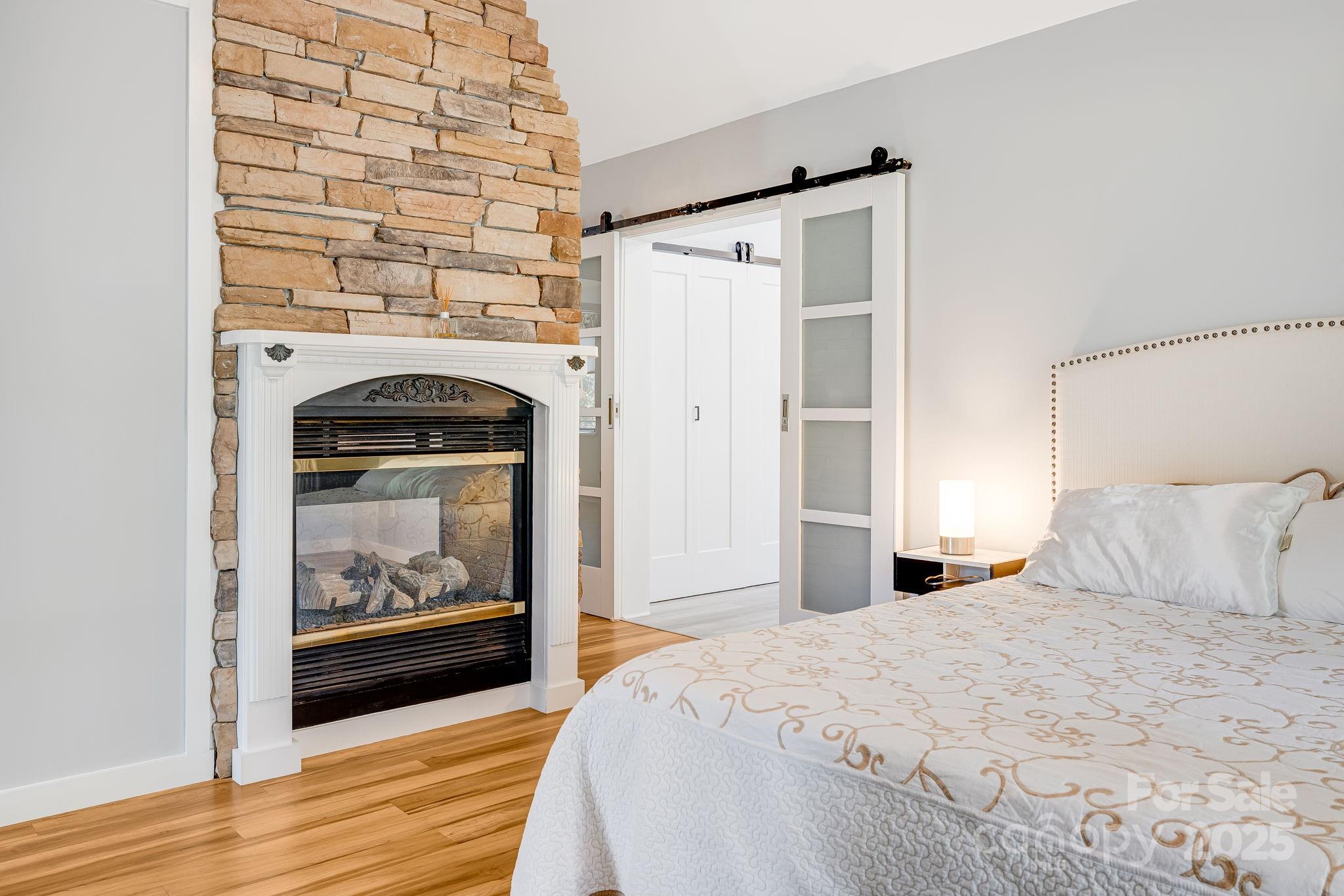 1387 Woods Ammons Road Mars Hill, NC 28754 - Photo 24 of 48 a bedroom with a bed and a fireplace