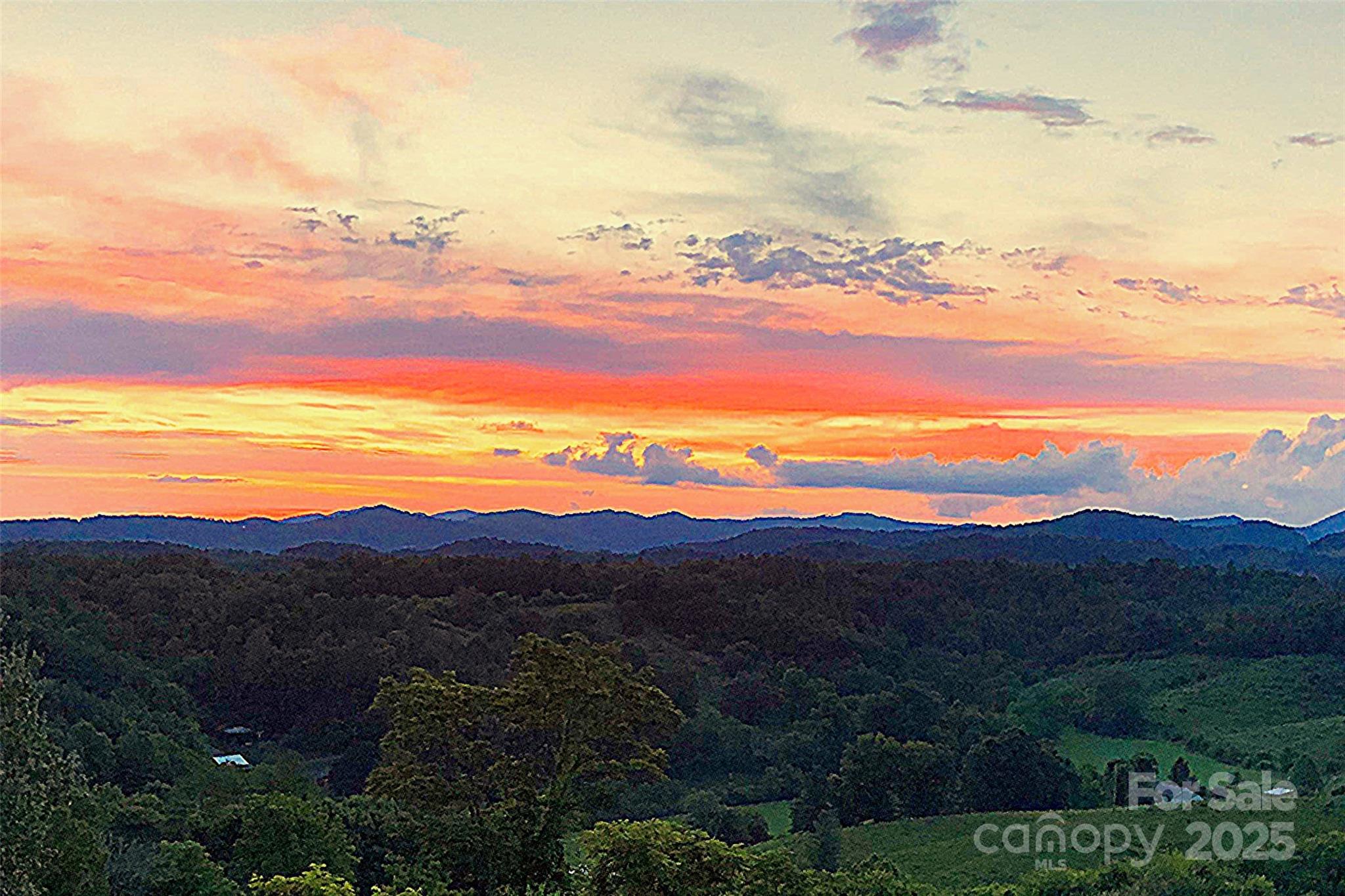 1387 Woods Ammons Road Mars Hill, NC 28754 - Photo 28 of 48 a view of a city with sunset view