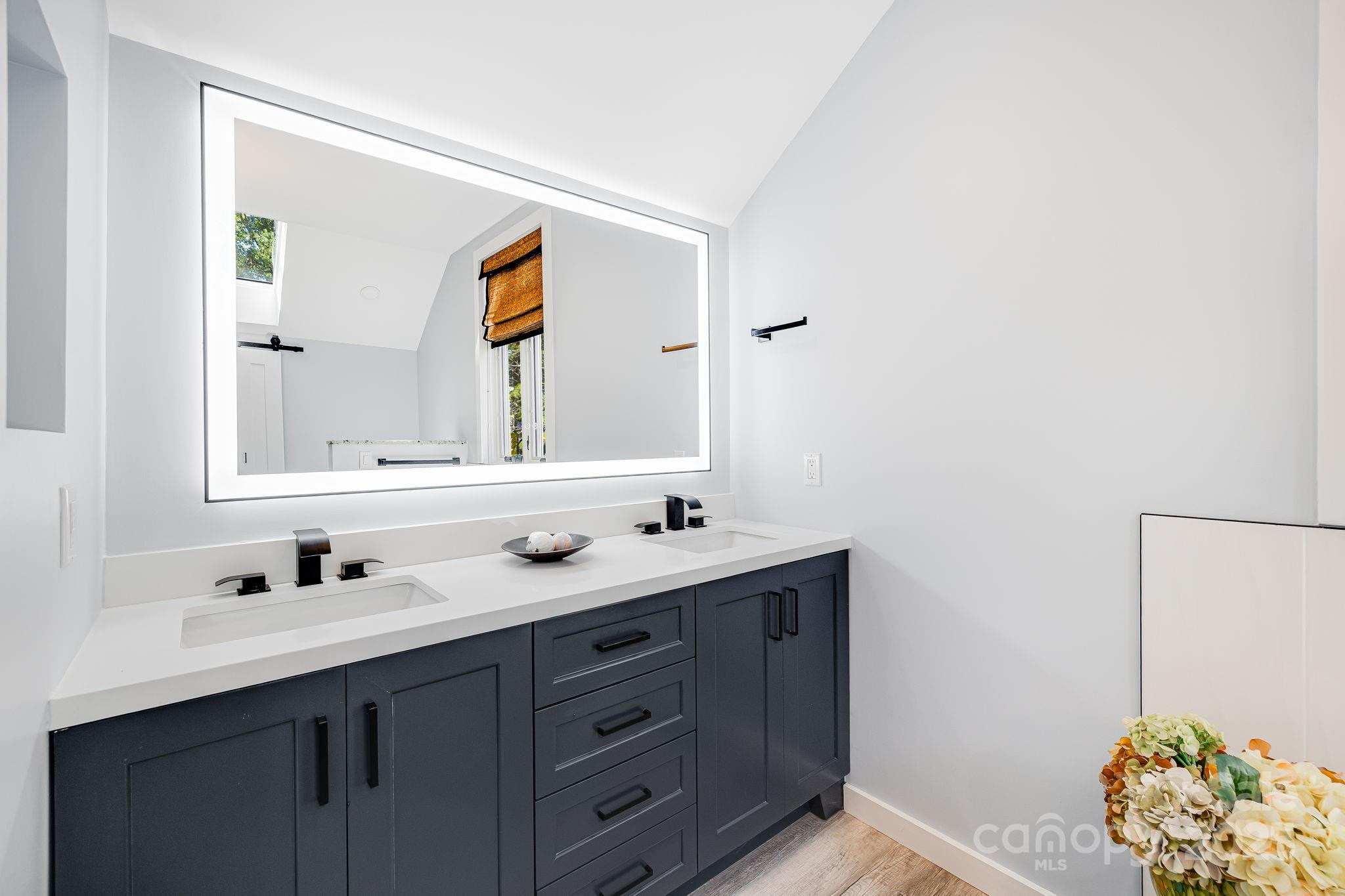 1387 Woods Ammons Road Mars Hill, NC 28754 - Photo 32 of 48 a bathroom with a double vanity sink and mirror