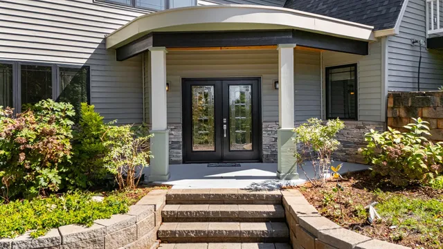 a vase of flowers sitting on a floor in front of a window