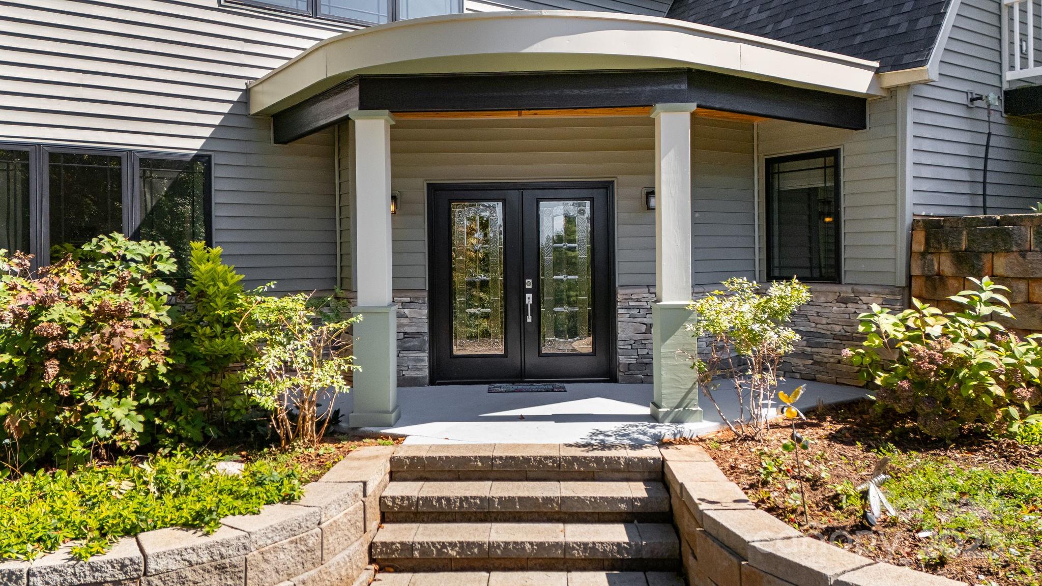 1387 Woods Ammons Road Mars Hill, NC 28754 - Photo 6 of 48 a front view of a house with a garden