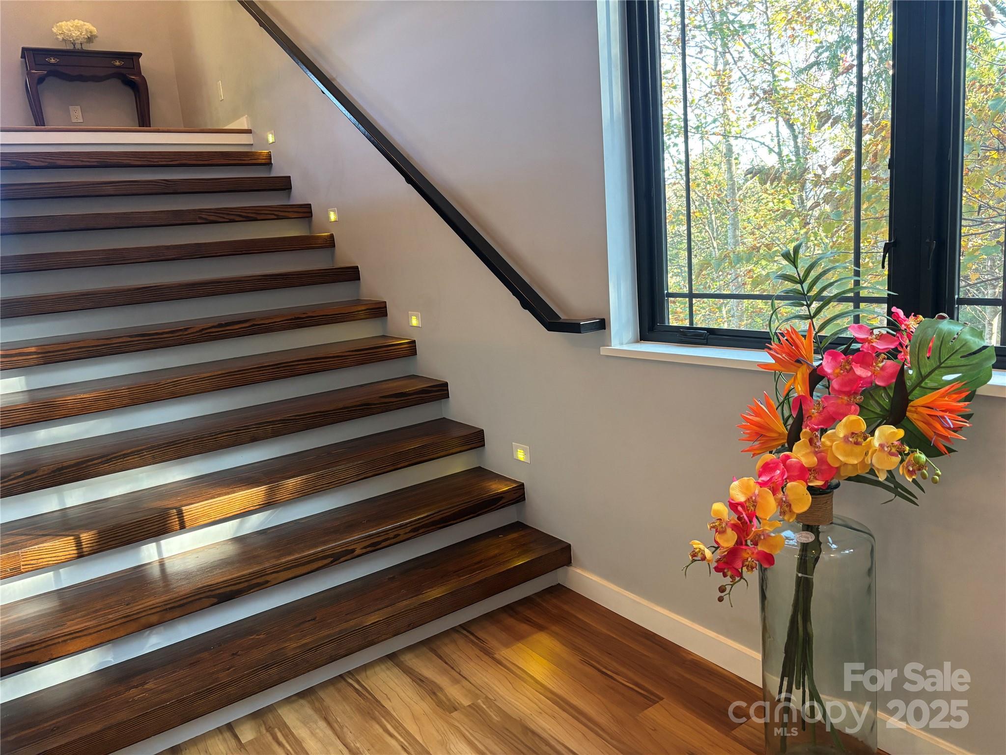 1387 Woods Ammons Road Mars Hill, NC 28754 - Photo 8 of 48 a vase of flowers sitting on a floor in front of a window