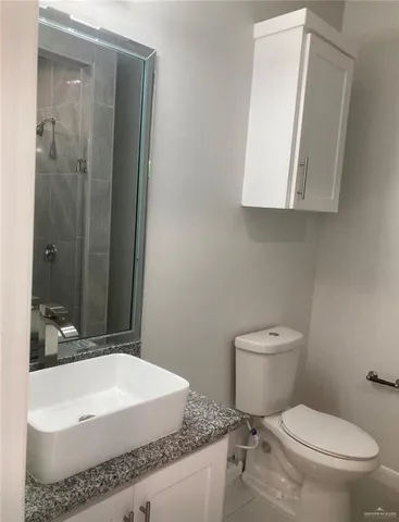 a bathroom with a glass shower door