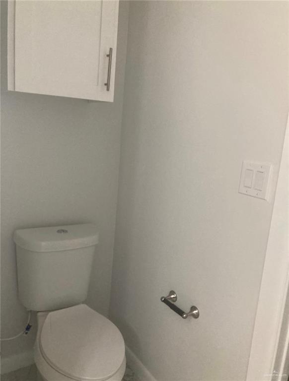 1411 South Flag Street, Unit 1 Pharr, TX 78577 - Photo 5 of 12 a white toilet sitting next to a white sink