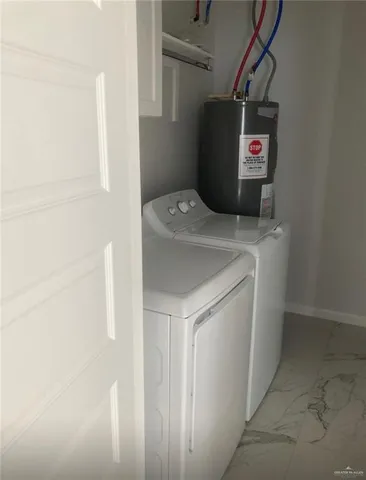 a bathroom with a granite countertop toilet and a sink