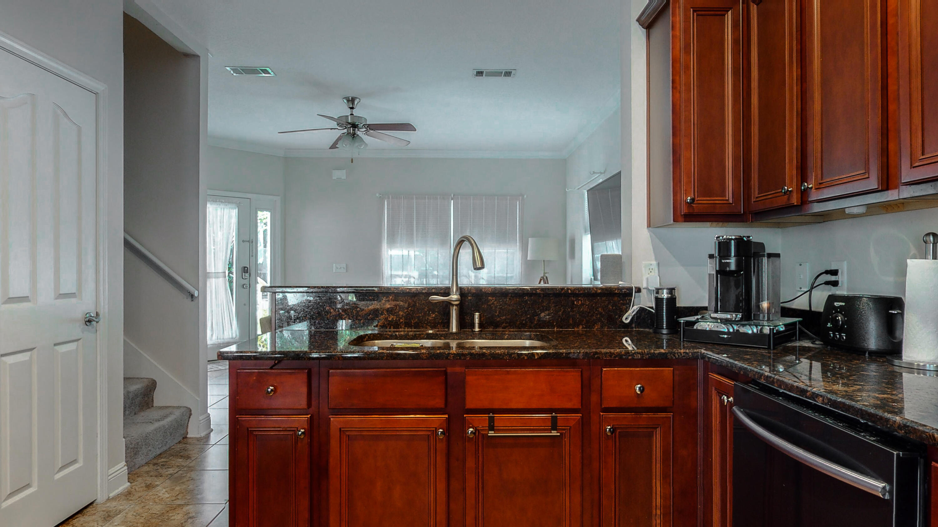 23 Beacon Point Drive Santa Rosa Beach, FL 32459 - Photo 9 of 33 a kitchen with stainless steel appliances granite countertop a sink a stove cabinets and wooden floor