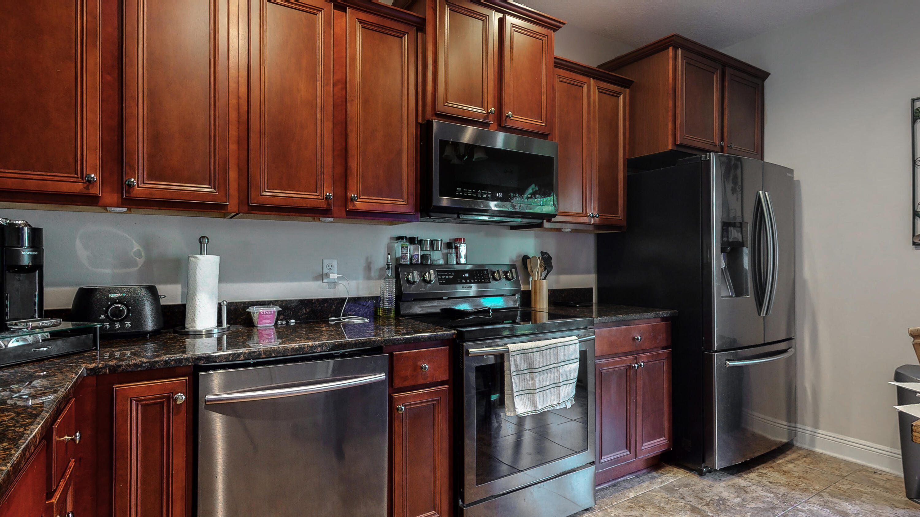 23 Beacon Point Drive Santa Rosa Beach, FL 32459 - Photo 10 of 33 a kitchen with stainless steel appliances granite countertop a refrigerator stove a sink and dishwasher