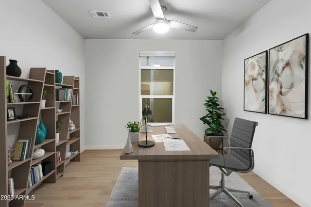 a view of a workspace with furniture and book shelf