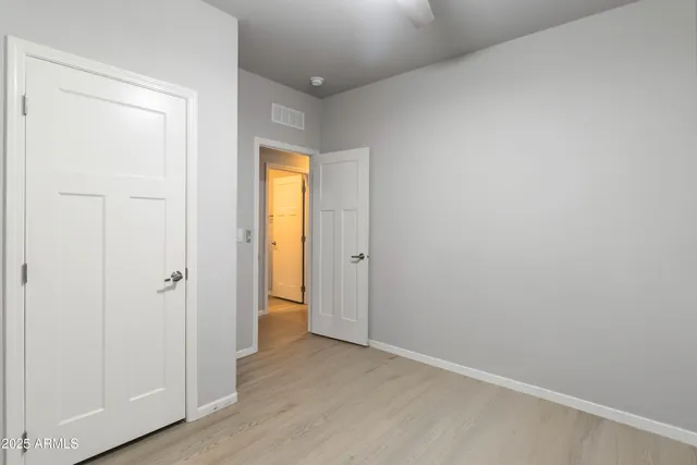an empty room with wooden floor and a window