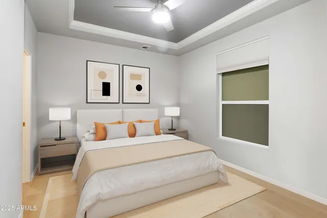 a bedroom with a bed and a ceiling fan