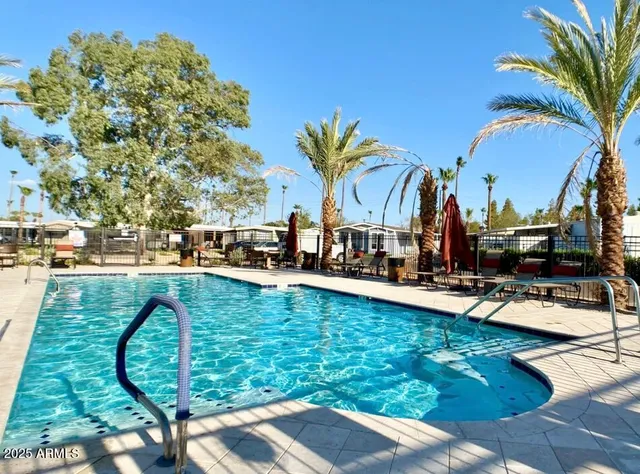 a view of swimming pool with outdoor seating and plants