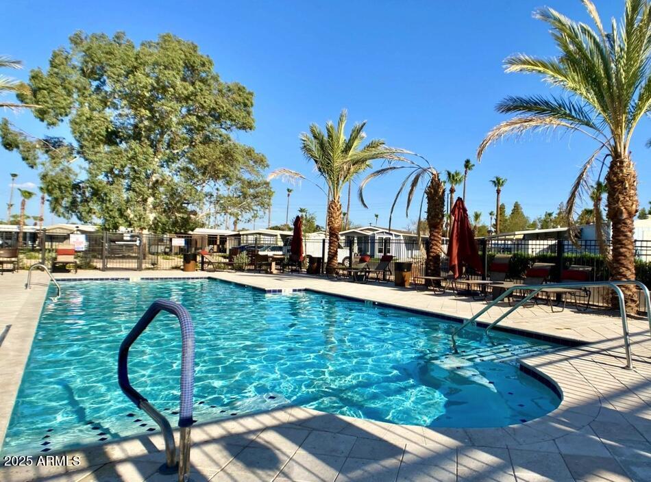 2727 East University Drive, Unit 146 Tempe, AZ 85288 - Photo 25 of 36 a view of swimming pool with outdoor seating and plants