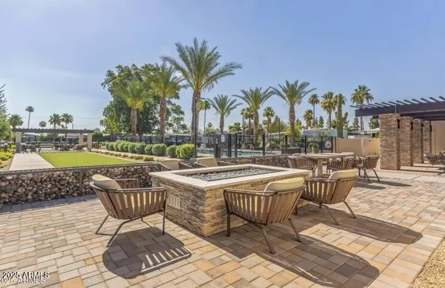a view of swimming pool with outdoor seating and plants