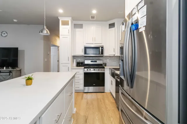 a kitchen with a refrigerator and a sink