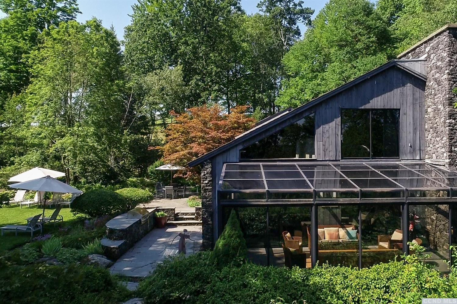 181 Golf Course Road Hillsdale, NY 12529 - Photo 13 of 44 a view of a backyard with plants and a patio