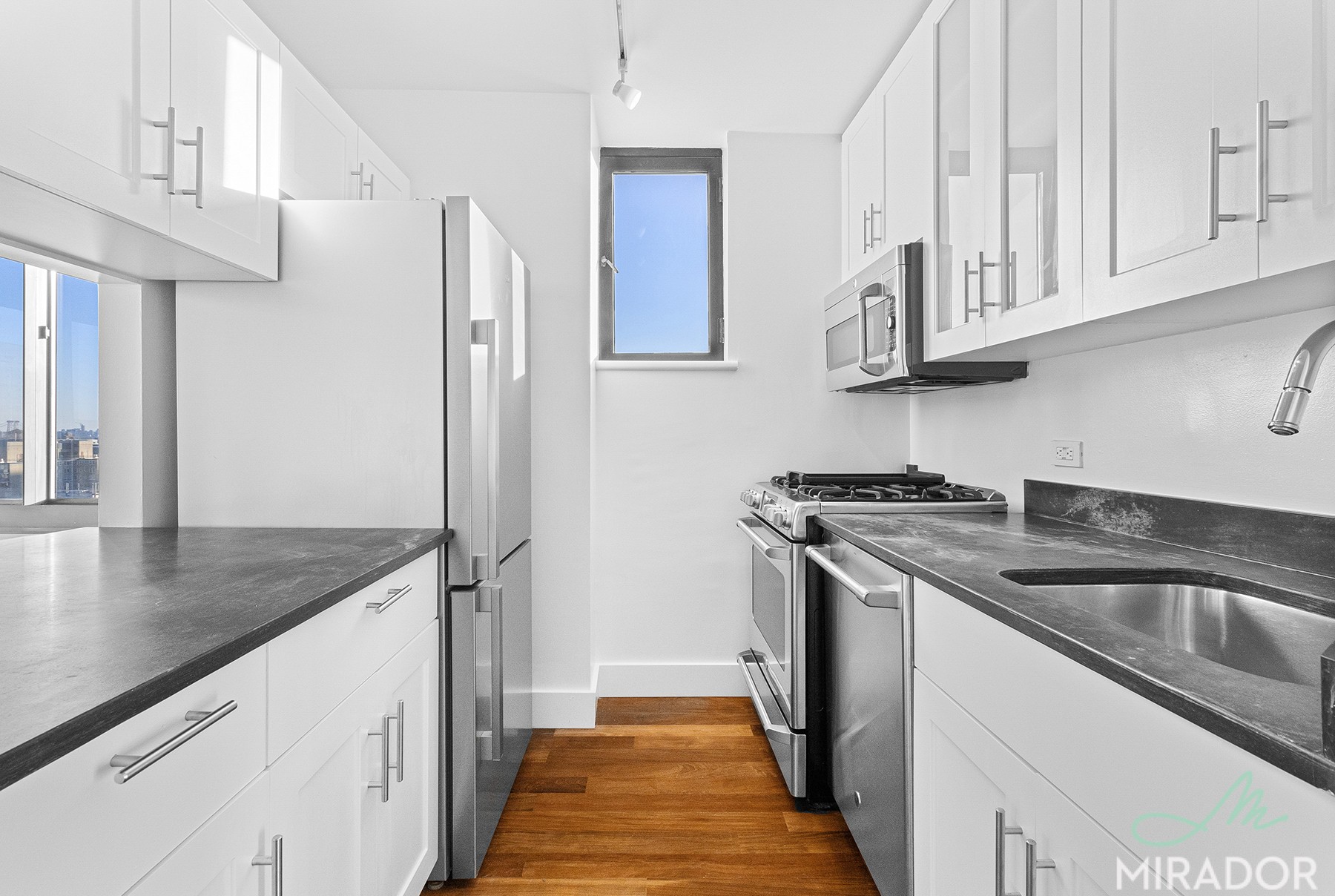 290 3rd Avenue, Unit 28C Manhattan, NY 10010 - Photo 8 of 28 a kitchen with stainless steel appliances granite countertop a sink stove and refrigerator