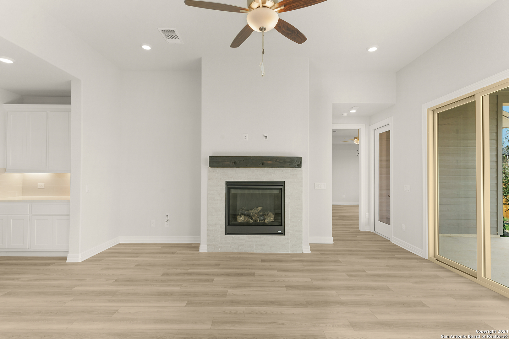 948 Nolte Bend Seguin, TX 78155 - Photo 13 of 39 a view of an empty room with wooden floor and a fireplace