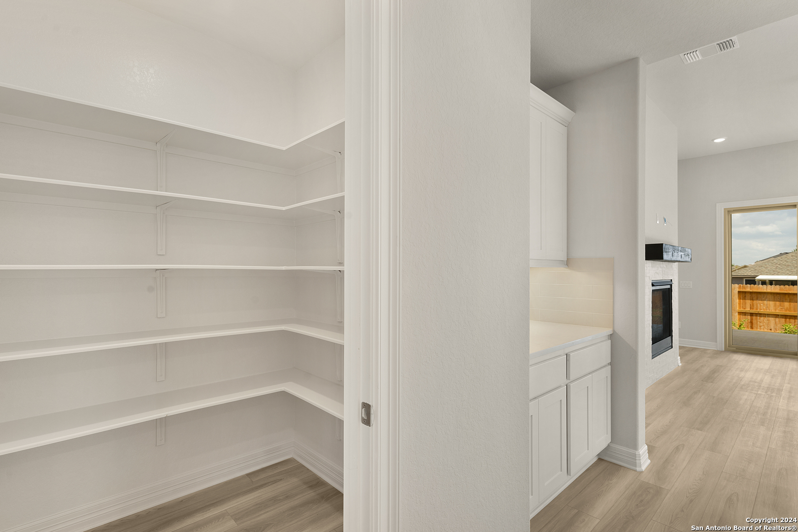 948 Nolte Bend Seguin, TX 78155 - Photo 14 of 39 a view of a hallway with wooden floor and a bathroom