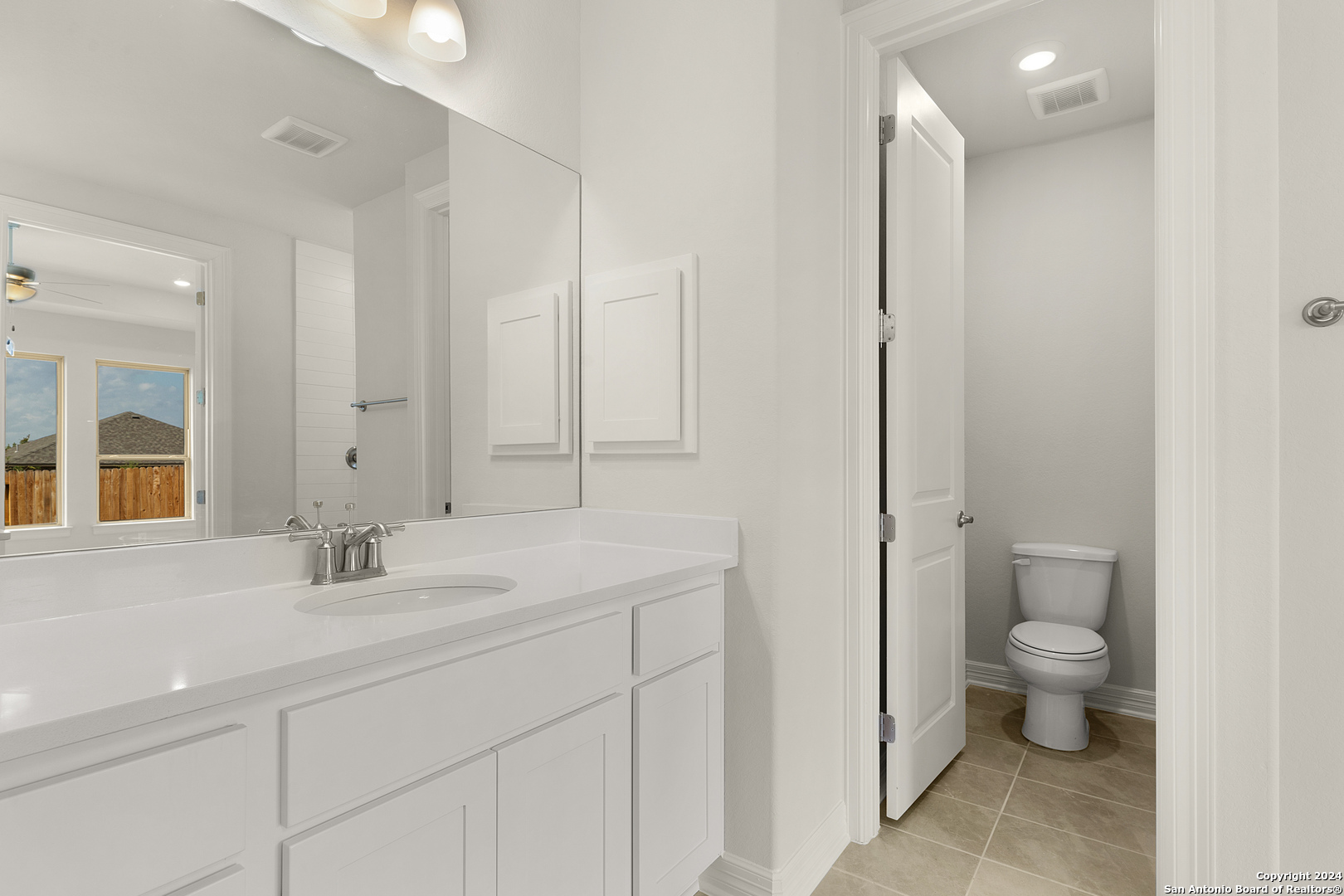 948 Nolte Bend Seguin, TX 78155 - Photo 22 of 39 a bathroom with a double vanity sink toilet and a mirror