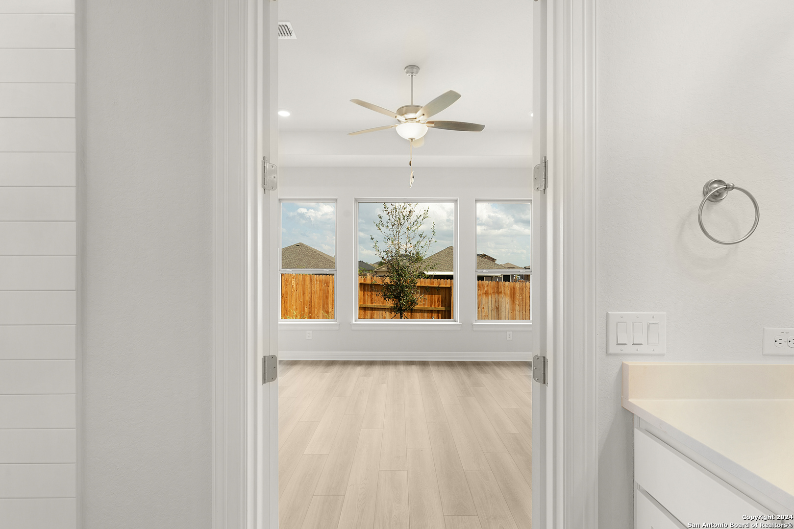 948 Nolte Bend Seguin, TX 78155 - Photo 24 of 39 a view of a bathroom with a window and a ceiling fan