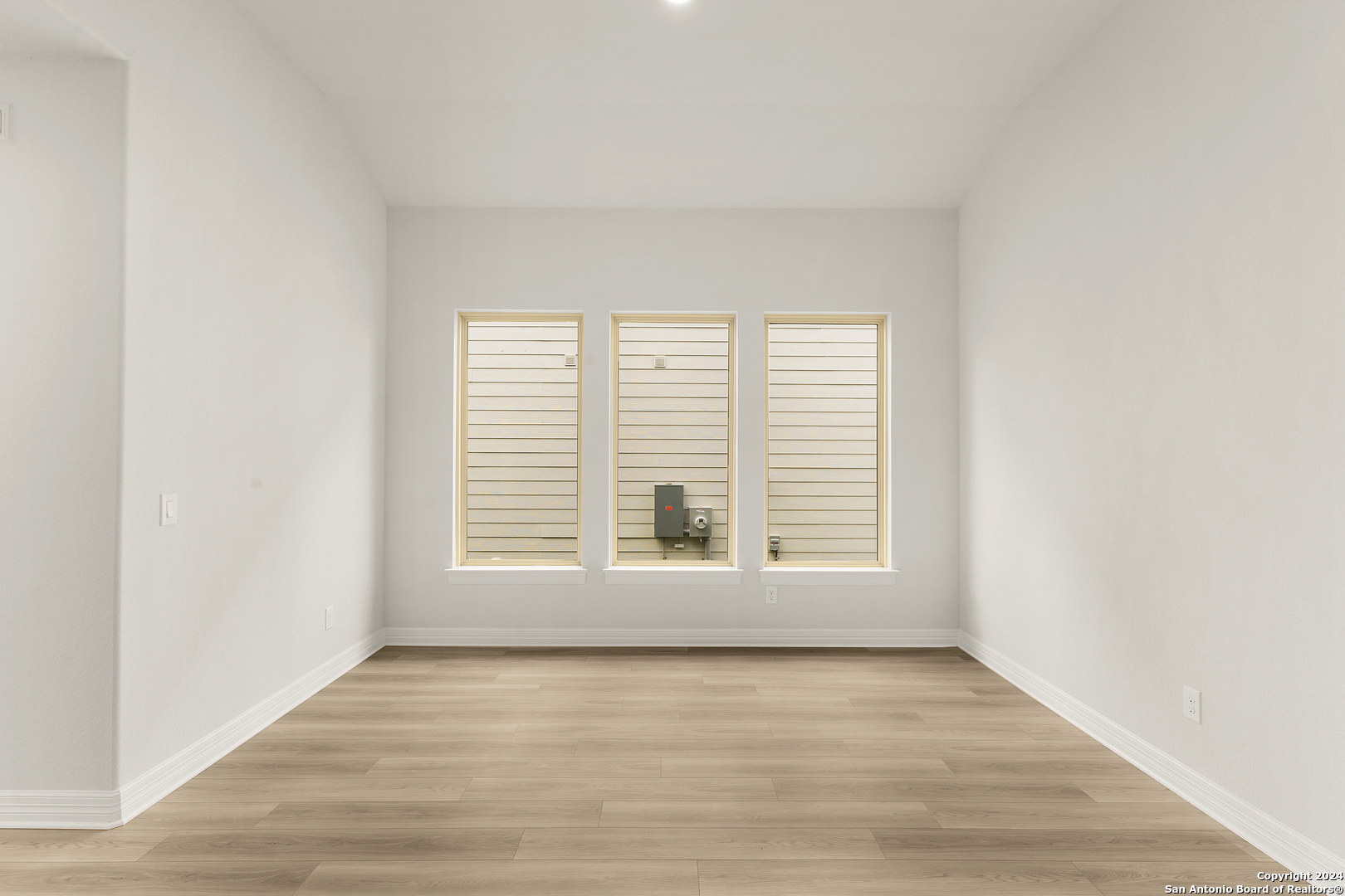 948 Nolte Bend Seguin, TX 78155 - Photo 7 of 39 a view of an empty room with wooden floor and a window